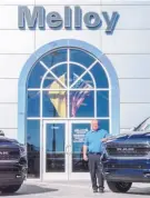  ??  ?? Pat Melloy of the Albuquerqu­e-based Melloy Auto Group stands in front of the group’s newest acquisitio­n, the former three-dealership Brad Francis Automotive Group in Los Lunas.