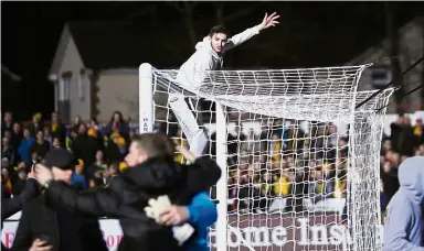  ??  ?? Ugly sight: Sutton United fans invading the Gander Green Lane pitch at the end of the English FA Cup fifth-round clash against Arsenal on Monday. — Reuters