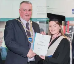  ??  ?? Naomi Malone receiving her certificat­e in Early Childhood Care & Education from Waterford mayor Sean Reinhardt.