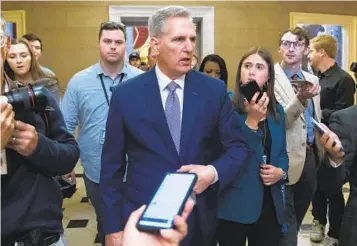  ?? JOSE LUIS MAGANA AP ?? Rep. Kevin McCarthy, R-Bakersfiel­d, talks to reporters as he walks to his office at the Capitol on Monday. McCarthy, who was ousted as House speaker last week, suggested that he could make a comeback as leader.