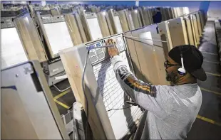  ?? AP ?? A technician works in October 2016 to prepare voting machines to be used in the presidenti­al election in Philadelph­ia. Intelligen­ce and law enforcemen­t officials are looking for ways to safeguard the vote against interferen­ce.