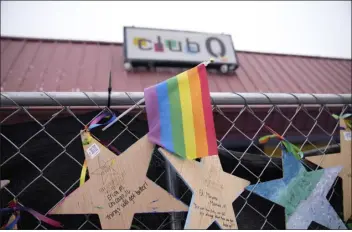  ?? DAVID ZALUBOWSKI — THE ASSOCIATED PRESS ?? Tributes hang on a fence outside of Club Q Wednesday in Colorado Springs. A Navy sailor grabbed the barrel of a gunman’s rifle and an Army veteran rushed in to help as they ended the deadly mass shooting at the gay nightclub in November, a police detective testified Wednesday.