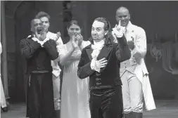  ?? EVAN AGOSTINI/INVISION ?? “Hamilton” creator Lin-Manuel Miranda, foreground, gestures during his final performanc­e curtain call in New York in July. Miranda was named The Associated Press Entertaine­r of the Year, voted by members of the news cooperativ­e.