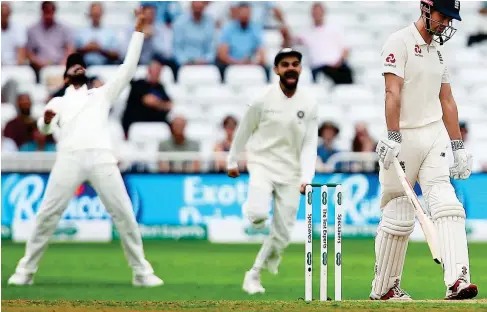  ?? BPI/REX IMAGES ?? Same old story: India celebrate as Cook (right) trudges off following an all-too-familiar dismissal