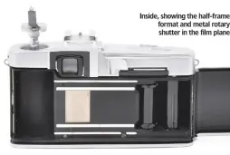  ??  ?? Inside, showing the half-frame format and metal rotary shutter in the film plane