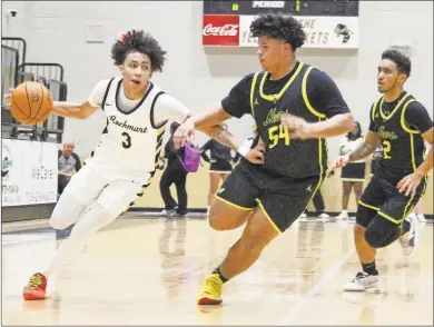  ?? Jeremy Stewart ?? Rockmart's Treylin Davis (3) pushes his way around North Murray's Nate Rivera during a Region 7-AA game Friday, Feb. 2, at Rockmart High School. Davis led all scorers with 32 points in the overtime win for the Jackets.