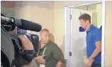  ?? ASSOCIATED PRESS ?? This still image is taken from a video showing United States swimmer James Feigen, right, leaving a court meeting early Friday in Rio de Janeiro.