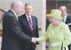  ?? Picture: AFP ?? LANDMARK. Queen Elizabeth II shakes hands with Northern Ireland Deputy First Minister Martin McGuinness watched by First Minister Peter Robinson and Prince Philip in Northern Ireland.