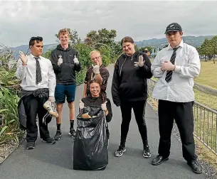  ??  ?? Before lockdown, students from the supported learning centre at Hutt Valley High School pick up rubbish in their community as part of their Duke of Edinburgh bronze award. Standing from left: Wyatt Wilson, 16, Danny Peckston (Ignite Sport), Nicholas Baldwin, 19, Tasmyn Margaret Grindlay, 20, Damon Allen, 26. Sitting: Jessie Goose (Ignite Sport).