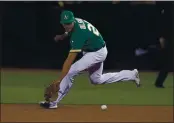  ?? NHAT V. MEYER — BAY AREA NEWS GROUP, FILE ?? The A’s Matt Olson (28) fields a ball hit by the Rays’ JiMan Choi (26) in the ninth inning of their American League wild-card game on Oct. 2 at the Coliseum in Oakland.