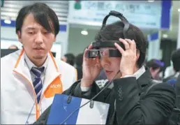  ?? PROVIDED TO CHINA DAILY ?? A visitor tries out Epson’s smart eyewear, augmented reality or AR set Moverio Pro BT-2000, at the Wearable Expo in Tokyo.