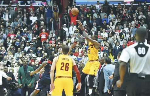  ?? TOMMY GILLIGAN / USA TODAY SPORTS ?? Cleveland Cavaliers captain LeBron James launches a 3-point buzzer-beater to force overtime against the Washington Wizards at Verizon Center in Washington on Monday. The Cavs went on to win 140-135.