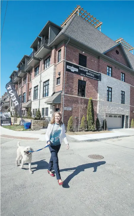  ?? PHOTOS: PETER J. THOMPSON / NATIONAL POST ?? Anita MacCallum with her dog Franklin at her rented townhouse unit on Ossington Avenue in Toronto. Below, the large rooftop terrace, which she’s looking forward to enjoying come summertime.