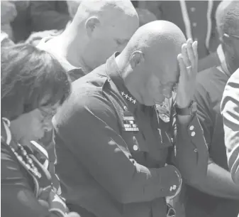  ?? DOUGLAS COLLIER, SHREVEPORT TIMES ?? David Brown attends a prayer service Friday in Dallas for the five police officers killed while watching over a protest Thursday.