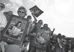  ??  ?? Fans wait for Danica Patrick to come out of her team transporte­r before the IndyCar Series Bombardier Learjet 500K on June 11, 2005 at the Texas Motor Speeday in Fort Worth. Patrick was coming off a fourth-place finish in the Indianapol­is 500. It was a highest finish for a woman in the race.