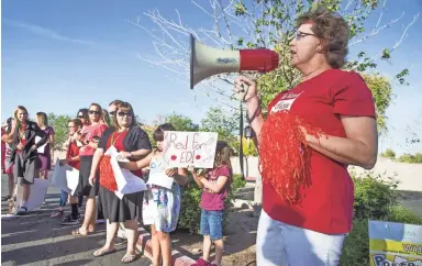  ?? TOM TINGLE/ THE REPUBLIC ?? Marthana Hall, a teacher at a school in Gilbert, leads chants on Wednesday during the statewide walk-in. The event was aimed at highlighti­ng the need for more funding for education.