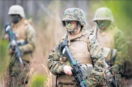  ?? Scott Olson Getty Images ?? A FEMALE private participat­es in a combat training exercise with other Marines at Camp Lejeune in North Carolina.