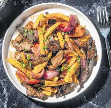  ?? REY LOPEZ For The Washington Post ?? Classic lomo saltado is a literal translatio­n of its Spanish name: A beef stir-fry.