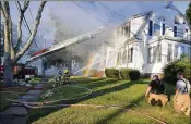  ??  ?? Firefighte­rs battle a house fire Thursday in North Andover, Mass., part of a series of gas explosions and fires triggered by a problem with a gas line.