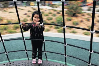  ?? Michael Macor / The Chronicle ?? Caroline Delacruz takes a spin at the newly redone Balboa Park, which has new playground­s.