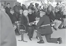  ?? J.B. Forbes/St. Louis Post-Dispatch/ TNS ??    Beverly and Steve Noller were presented the American flag at the end of the memorial service on Thursday for Vietnam War helicopter pilot Reginald Cleve at Jefferson Barracks National Cemetery. The Nollers are in-laws of the deceased Cleve.