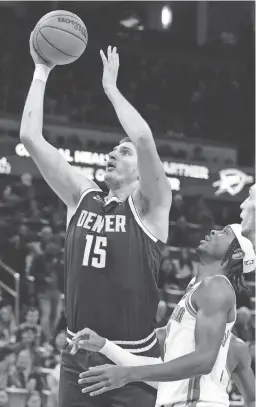  ?? SUE OGROCKI/AP ?? Nuggets center Nikola Jokic shoots against the Thunder on Nov. 23 in Oklahoma City.