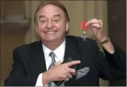  ?? MATTHEW FEARN — FOREIGN SUBSCRIBER, PA ?? In this Dec. 12, 2003file photo, Gerry Marsden holds his MBE. Marsden, the British singer and lead singer of Gerry and the Pacemakers, who was instrument­al in turning a song from the Rodgers and Hammerstei­n musical “Carousel” into one of the great anthems in the world of football, has died. He was 78.