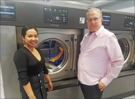  ?? DONNA ROVINS — DIGITAL FIRST MEDIA ?? Katherine Pasquale, left and Charles Pasquale are owners of the new Pottstown Express Laundry Center, 204 Shoemaker Road in Pottstown. The couple is shown here standing by the center’s largest washing machines, which can handle up to 90 pounds of...