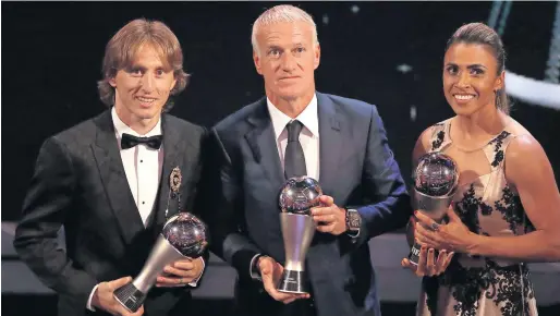  ?? Reuters ?? Luka Modric (left), Didier Deschamps (centre) and Marta pose with their Fifa awards at the Royal Festival Hall, London, on Monday night. —