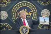  ?? EVAN VUCCI — THE ASSOCIATED PRESS FILE ?? President Donald Trump holds an image of the U.S. border wall being built between the U.S. and Mexico as he participat­es in a border security briefing in Yuma, Ariz.