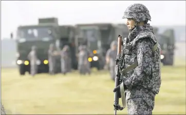  ?? EUGENE HOSHIKO — THE ASSOCIATED PRESS ?? A Japanese Air Self-Defense Force member stands guard during a training demonstrat­ion of surface-to-air intercepto­rs today at the U.S. Yokota Air Base in Japan. The training took place the same morning North Korea fired a missile over Japan.