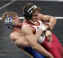  ?? Associated Press ?? Pitt’s Micky Phillippi, left, is one of three Panthers to advance to the quarterfin­als of the NCAA championsh­ips in St. Louis. He defeats N.C. State’s Jarrett Trombley Thursday in a match at 133 pounds.