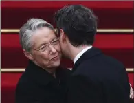  ?? (AP/Emmanuel Dunand) ?? New French Prime Minister Gabriel Attal (right) embraces outgoing prime minister Elisabeth Borne after the handover ceremony Tuesday in Paris.