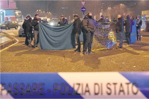  ??  ?? MANHUNT OVER: Italian police officers work next to the body of Anis Amri in a suburb of the northern city of Milan on Friday.