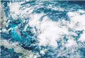  ?? NOAA/RAMMB/COURTESY ?? The tropical disturbanc­e expected to move over the Bahamas likely will become a tropical depression or even a tropical storm in the next day or so, the National Hurricane Center said at 8 p.m. Thursday.