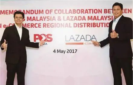  ?? PIC BY ASWADI ALIAS ?? Pos Malaysia group chief executive officer (CEO) Datuk Mohd Shukrie Mohd Salleh (left) and Lazada Malaysia CEO Hans-Peter Ressel at the signing of a memorandum of collaborat­ion in Kuala Lumpur yesterday.