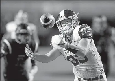  ?? Arkansas Democrat-Gazette/THOMAS METTHE ?? Bryant receiver Luke Curtis catches a 33-yard touchdown pass during the second quarter of Saturday night’s Salt Bowl at War Memorial Stadium in Little Rock. The Hornets defeated the Panthers 49-42 before a crowd of more than 32,000.