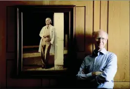  ?? HOWARD LIPIN — THE SAN DIEGO UNION-TRIBUNE — TNS ?? Dr. Peter Salk, one of Dr. Jonas Salk's sons, stands near a photo of his famous father, at the Salk Institute for Biological Studies in La Jolla The elder Salk discovered and developed the first successful inactivate­d polio vaccine.