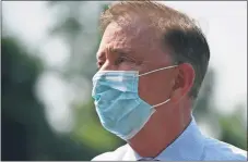  ?? Jessica Hill / Associated Press ?? Gov. Ned Lamont wearing a mask last year.