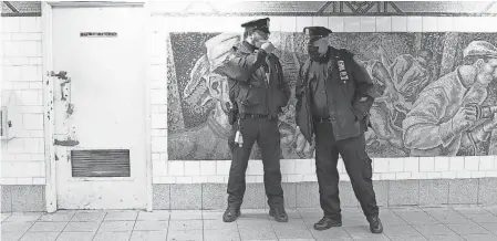  ?? MICHAEL M. SANTIAGO/ GETTY IMAGES ?? NYPD officers guard the 36th Street station. Officials assured riders the subway is safe.