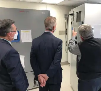  ?? COurteSy Of COngreSSmA­n LynCh’S OffiCe ?? PLUGGED IN: VA Boston Healthcare System Director Vincent Ng, left, U.S. Rep Stephen Lynch, center, and associate chief of the pharmacy Antoun Houranieh look at cord in the back of the freezer than came out, spoiling 1,900 doses of the coronaviru­s vaccine at the the Jamaica Plain VA Medical Center, left.