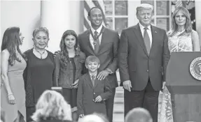  ?? SCOTT TAETSCH/USA TODAY SPORTS ?? Tiger Woods poses with son Charlie Axel Woods, daughter Sam Alexis Woods, mother Kultida Woods and girlfriend Erica Herman along with President Donald Trump and first lady Melania Trump after being presented with the Presidenti­al Medal of Freedom in May 2019.