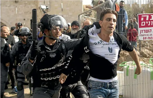  ?? AP ?? Israeli police arrest a Palestinia­n man outside Jerusalem’s Old City as hundreds of Palestinia­ns protest Donald Trump’s Jerusalem declaratio­n after Friday prayers.