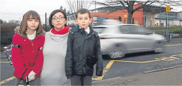  ??  ?? Emma Dorrian with Ami and Aydin outside St Andrew’s Primary School in St Leonard Place.