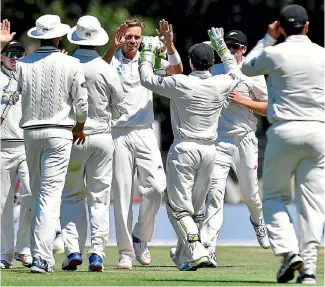  ?? PHOTO: GETTY IMAGES ?? Tim Southee (centre) is congratula­ted by teammates after collecting his 200th test wicket victim (Shakib Al Hasan) during Bangladesh’s second innings of the second test match at Hagley Oval yesterday.