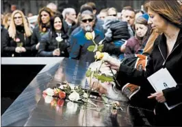  ?? JUSTIN LANE/EPA-EFE ?? People pay their respects at the Sept. 11 memorial on Monday to victims of the 1993 World Trade Center bombing.