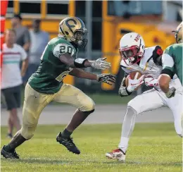  ?? KRISTEN ZEIS/STAFF FILE ?? The Cox Falcons' Isi Etute, left, and Cullen Lyons move toward Bayside ball-carrier Malik Johnson in August 2018 at Cox High in Virginia Beach.