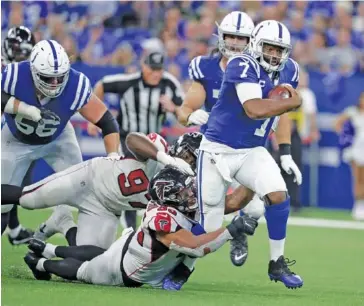  ?? AP PHOTO/MICHAEL CONROY ?? Indianapol­is Colts quarterbac­k Jacoby Brissett (7) escapes Atlanta Falcons defensive tackle Jack Crawford (95) during Sunday’s game in Indianapol­is. The Colts won 27-24.