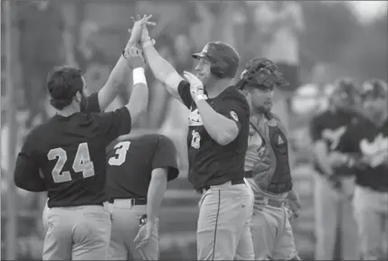  ?? DAVID BEBEE, RECORD STAFF ?? Panthers slugger Sean Reilly gets congratula­tions after his grand slam home run at Jack Couch Park against Hamilton on Thursday night.