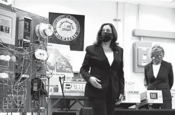  ?? SUSAN WALSH/AP ?? Vice President Kamala Harris tours clean energy laboratori­es at the University of Wisconsin-Milwaukee during a visit last month to promote President Joe Biden’s infrastruc­ture plan. Sen. Tammy Baldwin, D-Wis., is seen with Harris.